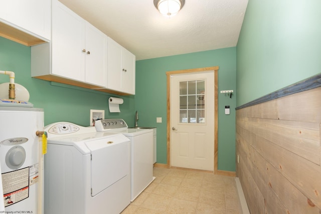 390 Aster Cir, Terra Alta, WV 26764 - laundry room with cabinet space, water heater, washer and dryer, and baseboards