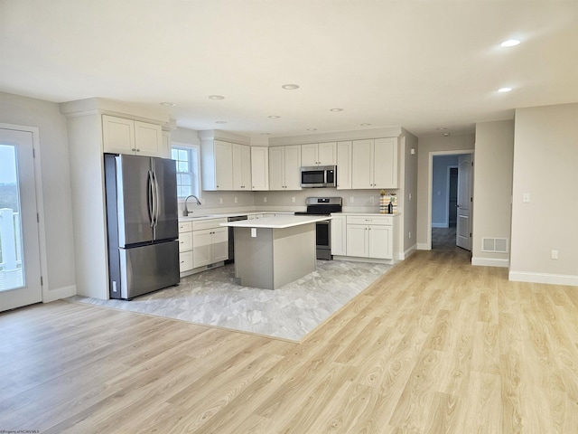 835 Auburn Ln, Flemington, WV 26347 - kitchen featuring stainless steel appliances, light wood-style flooring, a kitchen island, light countertops, and recessed lighting