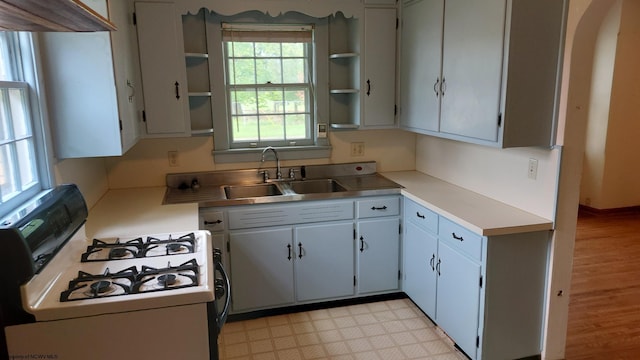 110 15th St, Elkins, WV 26241 - kitchen featuring white gas range, open shelves, a sink, light countertops, and light flooring