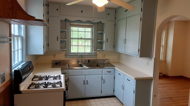 110 15th St, Elkins, WV 26241 - kitchen featuring white gas stove, a sink, open shelves, a ceiling fan, and light countertops