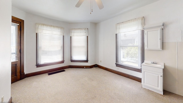 820 Field St, Fairmont, WV 26554 - empty room with light carpet, a sink, ceiling fan, and baseboards