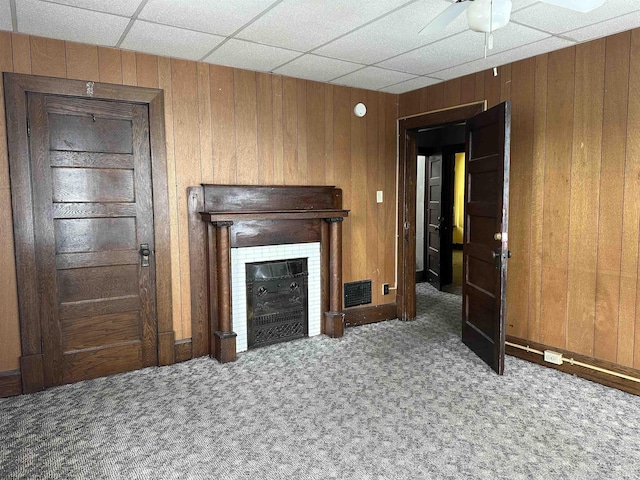 820 Field St, Fairmont, WV 26554 - unfurnished living room featuring carpet flooring, ceiling fan, wood walls, a fireplace, and baseboards
