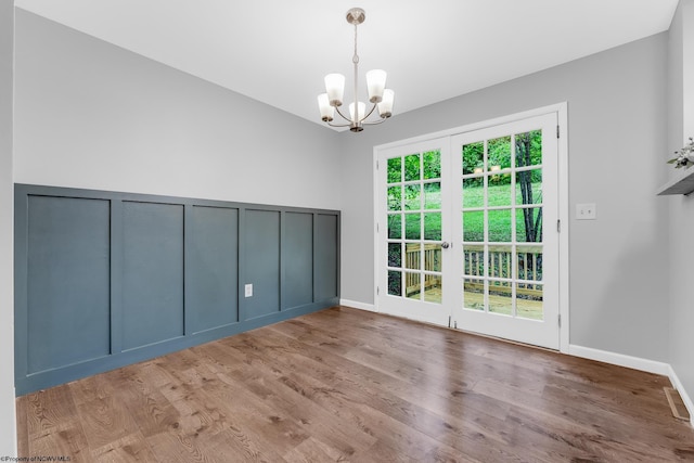 135 Celtic Dr, Clarksburg, WV 26301 - empty room with a chandelier, french doors, wood finished floors, and baseboards