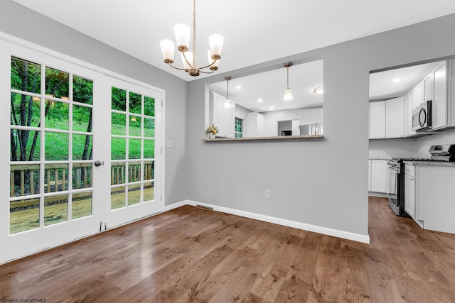 135 Celtic Dr, Clarksburg, WV 26301 - unfurnished dining area featuring a chandelier, baseboards, and dark wood finished floors