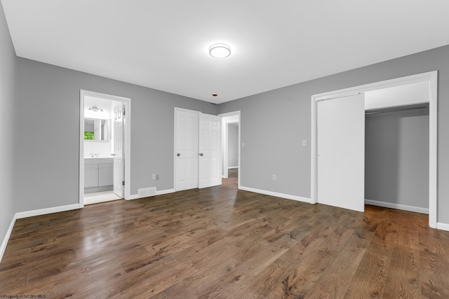 135 Celtic Dr, Clarksburg, WV 26301 - unfurnished bedroom featuring wood finished floors, baseboards, and connected bathroom