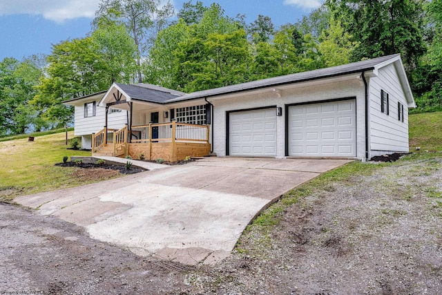 135 Celtic Dr, Clarksburg, WV 26301 - ranch-style home with a porch, concrete driveway, an attached garage, and a front yard