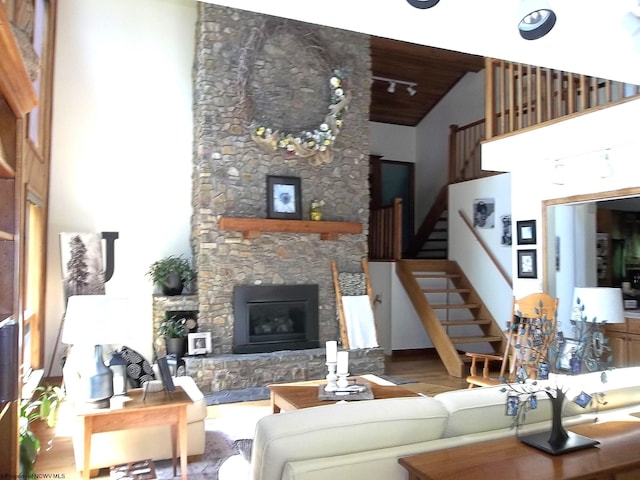 444 Gordon Rd, Beverly, WV 26253 - living room with high vaulted ceiling, a stone fireplace, stairway, and wood finished floors