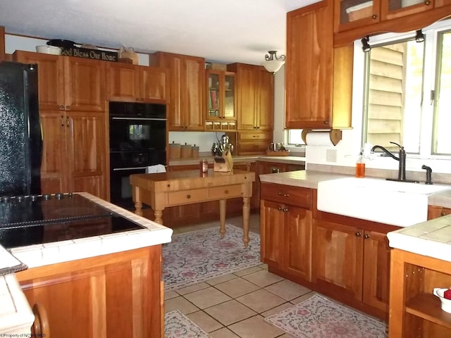 444 Gordon Rd, Beverly, WV 26253 - kitchen featuring black appliances, tile countertops, a sink, brown cabinetry, and light tile patterned floors