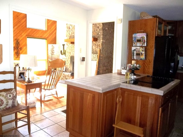 444 Gordon Rd, Beverly, WV 26253 - kitchen with black electric cooktop, tile countertops, brown cabinetry, and light tile patterned floors