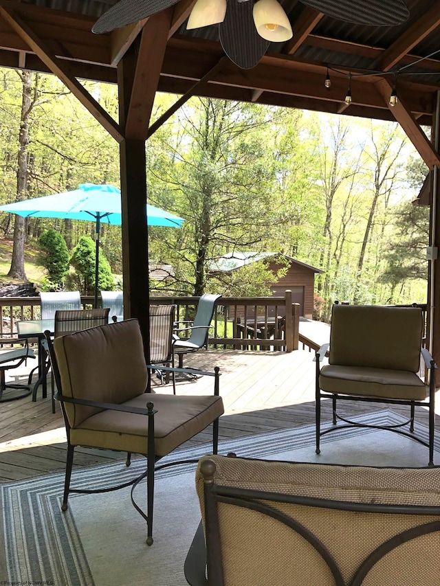 444 Gordon Rd, Beverly, WV 26253 - deck with outdoor dining area, a ceiling fan, and an outbuilding