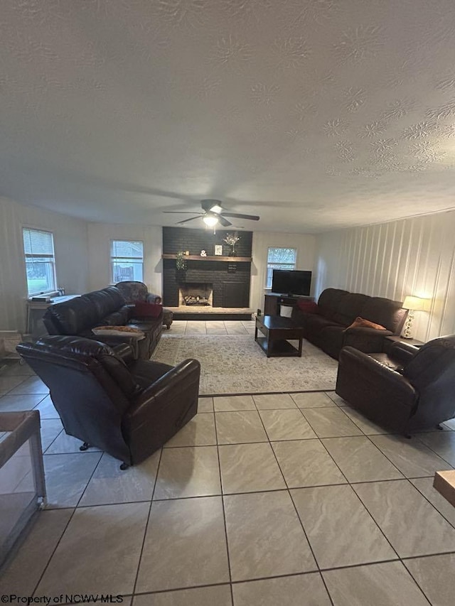 14 Myrna St, Buckhannon, WV 26201 - tiled living room featuring a textured ceiling, a ceiling fan, and a fireplace with raised hearth