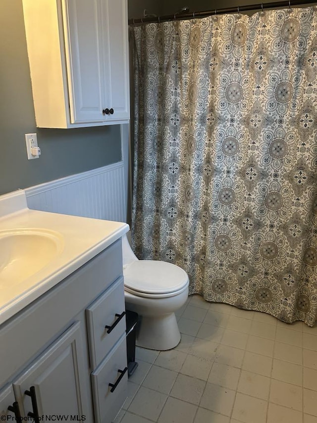 14 Myrna St, Buckhannon, WV 26201 - bathroom with vanity, a wainscoted wall, toilet, tile patterned floors, and a shower with curtain