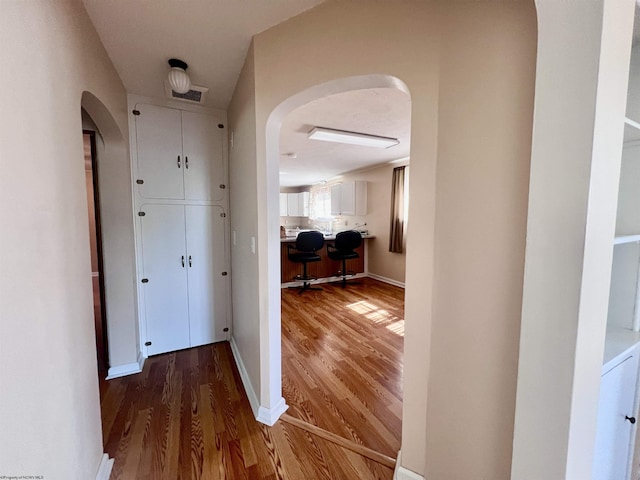 600 Wilson St, Elkins, WV 26241 - corridor featuring arched walkways, wood finished floors, and baseboards