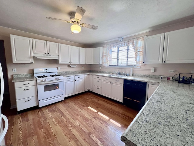 600 Wilson St, Elkins, WV 26241 - kitchen featuring gas range gas stove, black dishwasher, under cabinet range hood, white cabinets, and wood finished floors