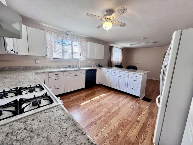 600 Wilson St, Elkins, WV 26241 - kitchen featuring dishwasher, freestanding refrigerator, range hood, a peninsula, and white cabinetry