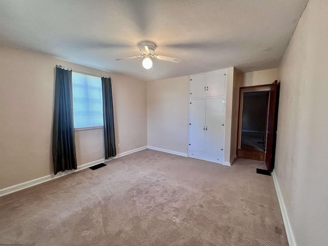 600 Wilson St, Elkins, WV 26241 - unfurnished bedroom with light carpet, baseboards, and ceiling fan