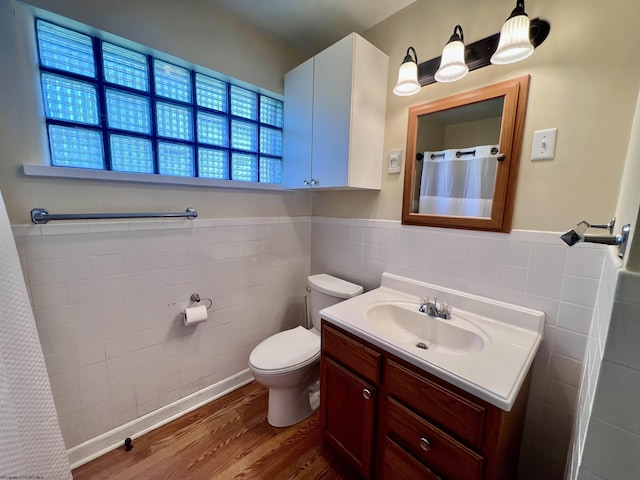 600 Wilson St, Elkins, WV 26241 - full bathroom featuring tile walls, wood finished floors, vanity, toilet, and a wainscoted wall