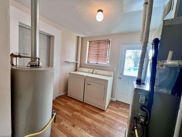 600 Wilson St, Elkins, WV 26241 - laundry room featuring washer and dryer, water heater, a textured ceiling, and light wood-type flooring