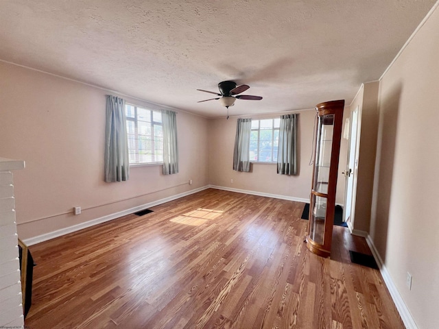600 Wilson St, Elkins, WV 26241 - spare room featuring light wood-style flooring, ceiling fan, a textured ceiling, and baseboards