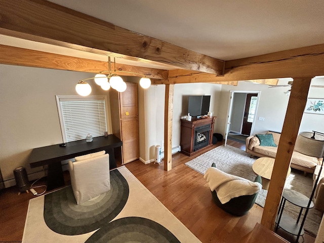 420 Fairfax Ave, Davis, WV 26260 - living room featuring wood finished floors, a baseboard heating unit, baseboards, beam ceiling, and a fireplace