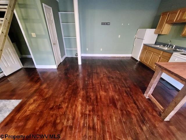 140 Locust Ave Unit 6, Fairmont, WV 26554 - kitchen with dark wood finished floors, dark countertops, freestanding refrigerator, and a sink