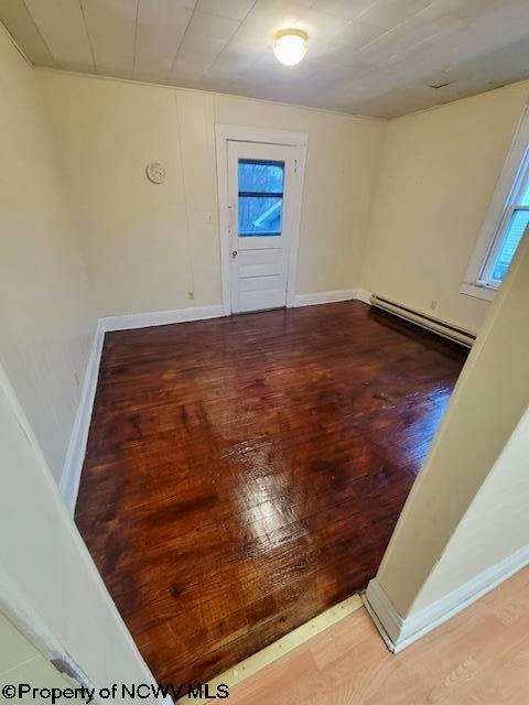140 Locust Ave Unit 6, Fairmont, WV 26554 - empty room featuring baseboard heating, wood finished floors, and baseboards