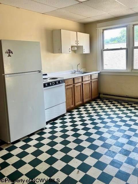 140 Locust Ave Unit 6, Fairmont, WV 26554 - kitchen with white appliances, light countertops, light floors, a sink, and brown cabinetry