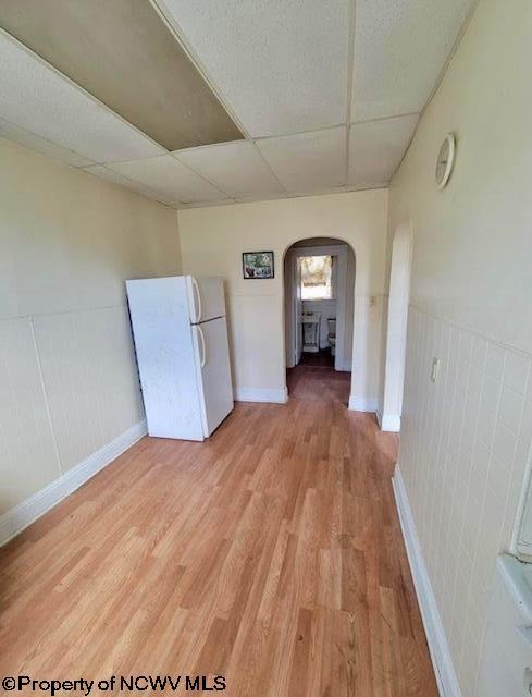 140 Locust Ave Unit 6, Fairmont, WV 26554 - empty room with a paneled ceiling, arched walkways, light wood-type flooring, and baseboards