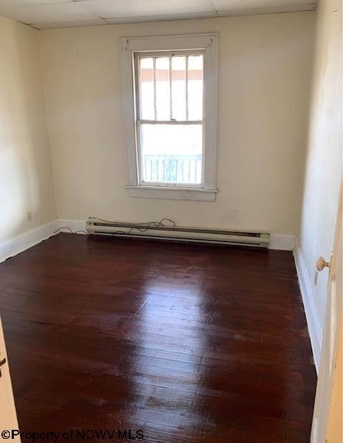 140 Locust Ave Unit 6, Fairmont, WV 26554 - unfurnished room featuring dark wood-style flooring, baseboards, and a baseboard heating unit