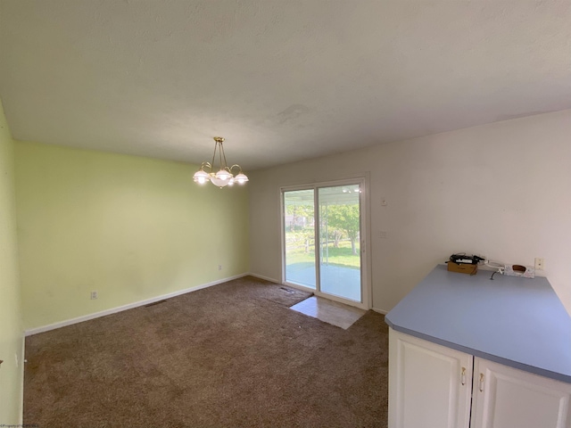 206 Evergreen Dr, Elkins, WV 26241 - unfurnished dining area with dark colored carpet, a chandelier, and baseboards