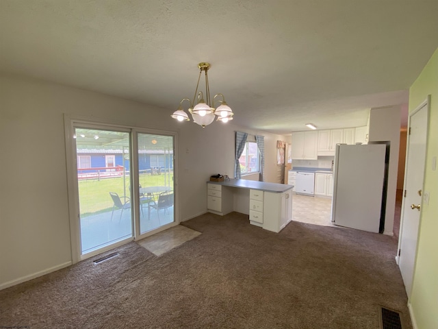 206 Evergreen Dr, Elkins, WV 26241 - kitchen with white appliances, a peninsula, white cabinetry, carpet flooring, and a chandelier