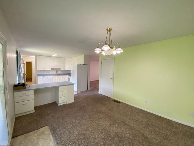 206 Evergreen Dr, Elkins, WV 26241 - kitchen featuring white appliances, a peninsula, carpet flooring, white cabinets, and pendant lighting