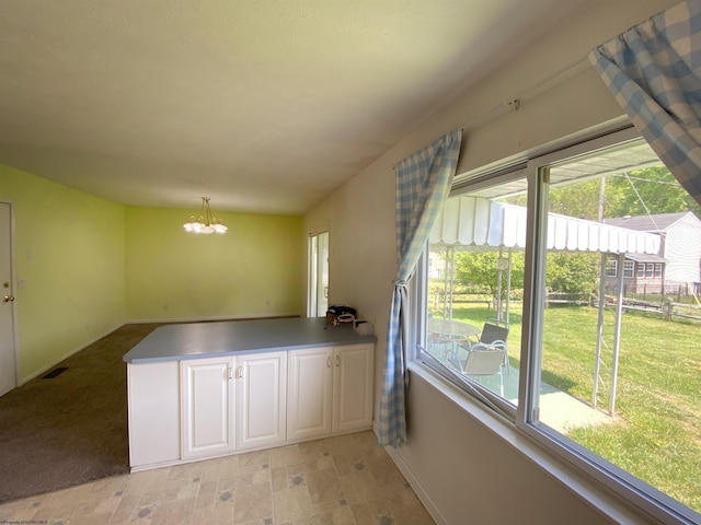 206 Evergreen Dr, Elkins, WV 26241 - kitchen featuring a chandelier, plenty of natural light, baseboards, and a peninsula