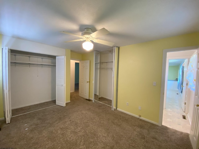 206 Evergreen Dr, Elkins, WV 26241 - unfurnished bedroom featuring two closets, carpet, baseboards, and a ceiling fan