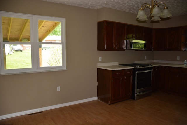 84 Chapman Ln, Weston, WV 26452 - kitchen featuring stainless steel appliances, a chandelier, light countertops, light wood-style floors, and baseboards