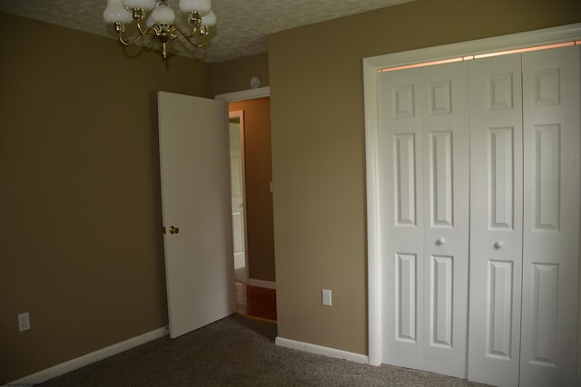 84 Chapman Ln, Weston, WV 26452 - unfurnished bedroom with a chandelier, dark carpet, a closet, and baseboards