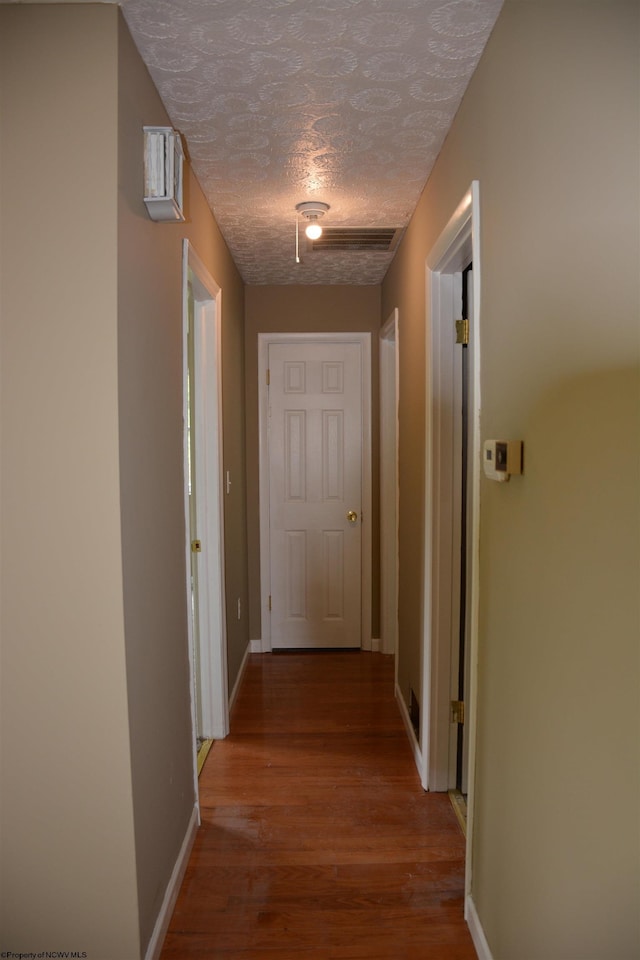 84 Chapman Ln, Weston, WV 26452 - hall with wood finished floors, a textured ceiling, and baseboards