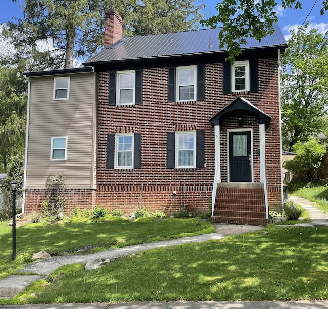 5 Key St, Elkins, WV 26241 - view of front of house featuring brick siding, a chimney, a front yard, and metal roof