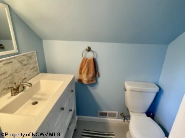5 Key St, Elkins, WV 26241 - bathroom with vaulted ceiling, toilet, and vanity