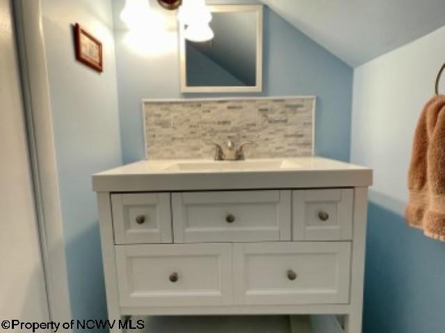 5 Key St, Elkins, WV 26241 - bathroom featuring vanity and vaulted ceiling