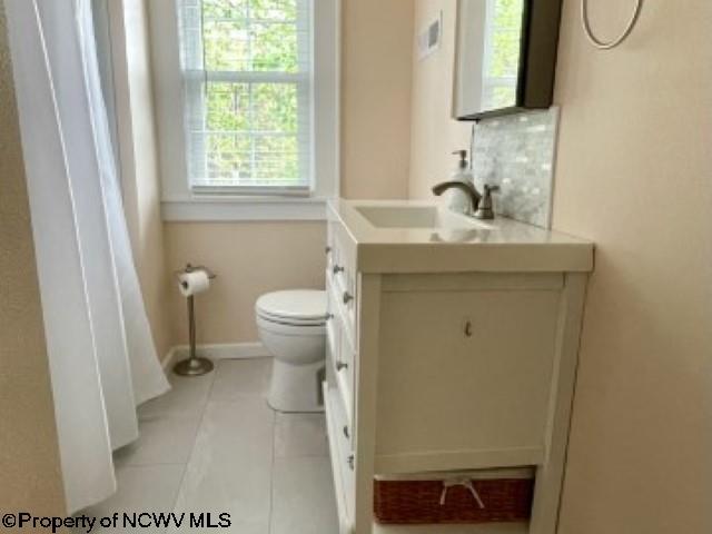 5 Key St, Elkins, WV 26241 - bathroom with vanity, toilet, tasteful backsplash, baseboards, and tile patterned flooring