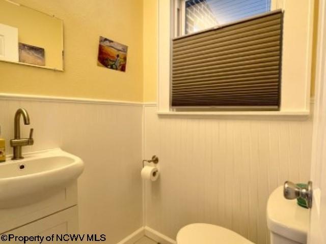 5 Key St, Elkins, WV 26241 - half bathroom featuring toilet, wainscoting, and vanity