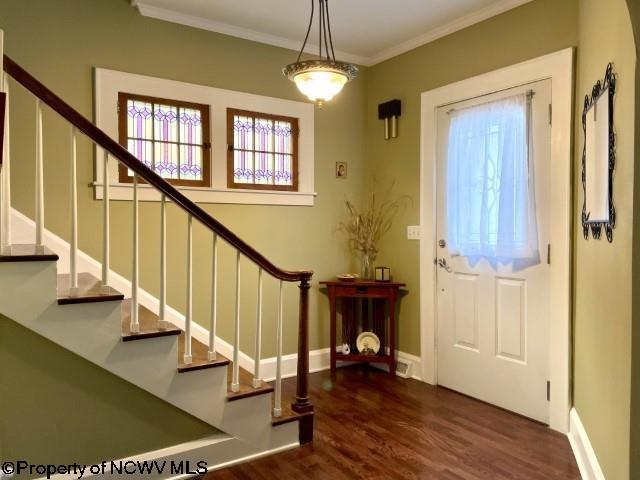 5 Key St, Elkins, WV 26241 - entrance foyer featuring wood finished floors, crown molding, stairs, healthy amount of natural light, and baseboards