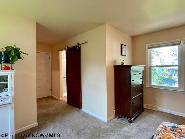 5 Key St, Elkins, WV 26241 - carpeted bedroom featuring a barn door and baseboards