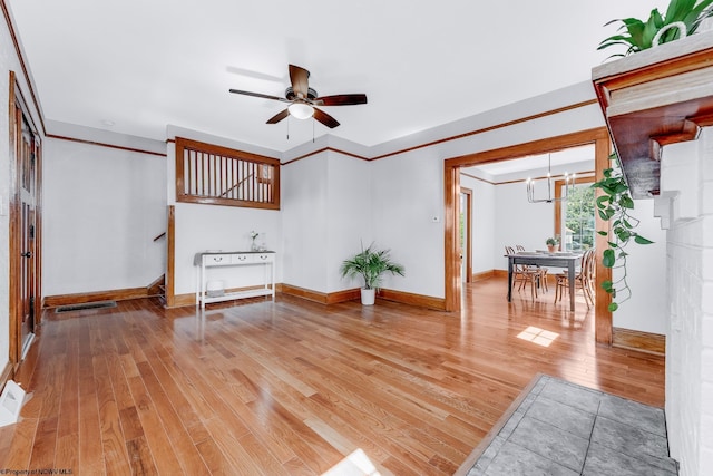 303 Saint Clair St, Clarksburg, WV 26301 - unfurnished living room featuring a chandelier, light wood-style floors, ceiling fan, baseboards, and stairway