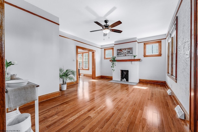 303 Saint Clair St, Clarksburg, WV 26301 - unfurnished living room with ceiling fan, baseboards, light wood-type flooring, and a brick fireplace