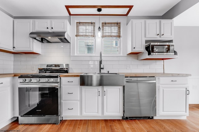 303 Saint Clair St, Clarksburg, WV 26301 - kitchen with appliances with stainless steel finishes, exhaust hood, a sink, and white cabinetry