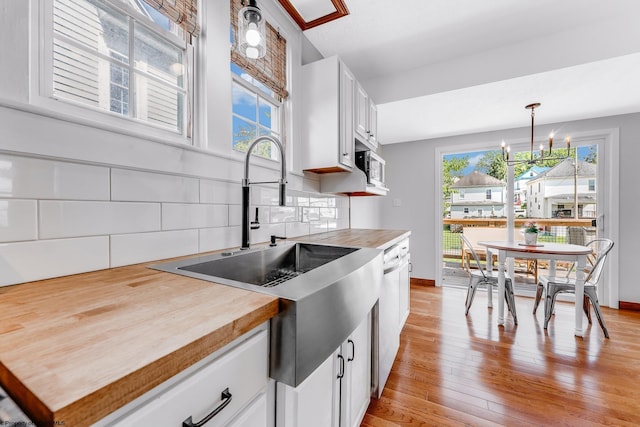 303 Saint Clair St, Clarksburg, WV 26301 - kitchen featuring wooden counters, a sink, backsplash, white cabinetry, and light wood finished floors