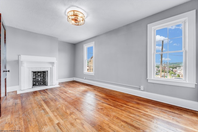303 Saint Clair St, Clarksburg, WV 26301 - unfurnished living room with a fireplace, baseboards, and healthy amount of natural light