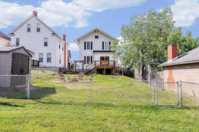 303 Saint Clair St, Clarksburg, WV 26301 - back of property with an outdoor fire pit, a wooden deck, a gate, and stairs